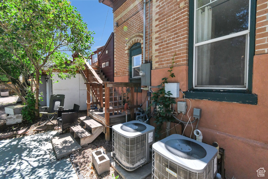 View of home\\\\\\\\\\\\\\\'s exterior featuring stairway, brick siding, and a patio