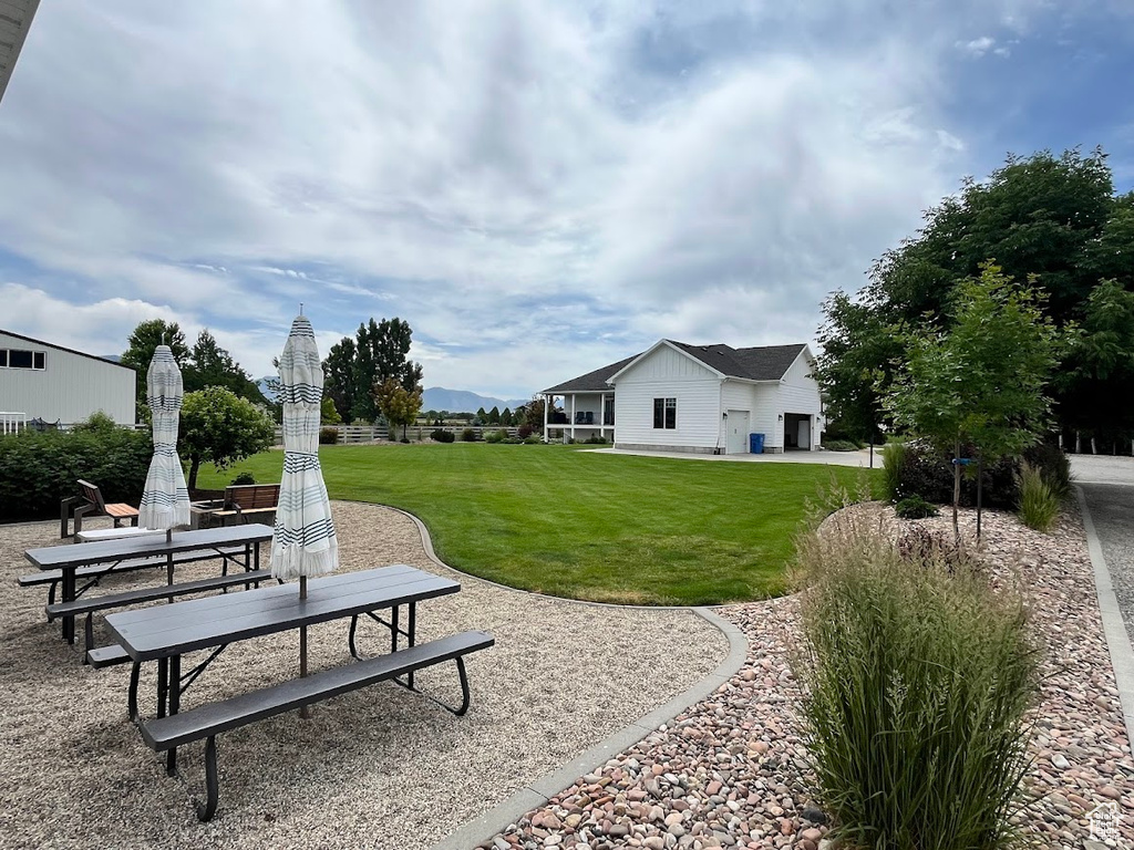 View of green lawn featuring a patio area