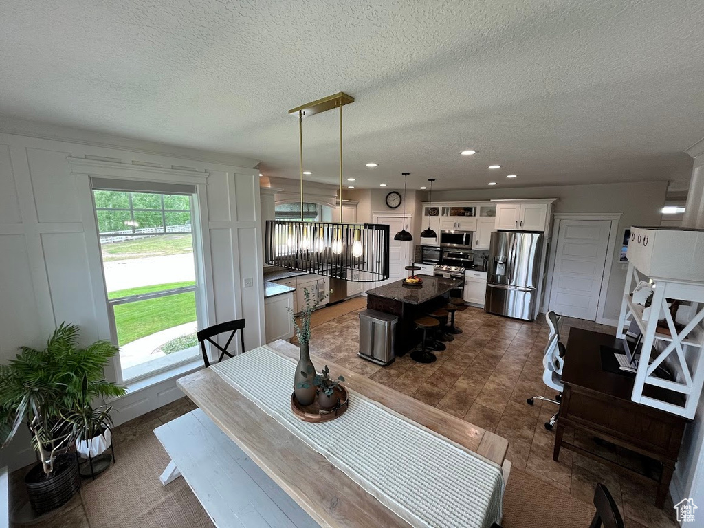 Dining space with a textured ceiling and recessed lighting