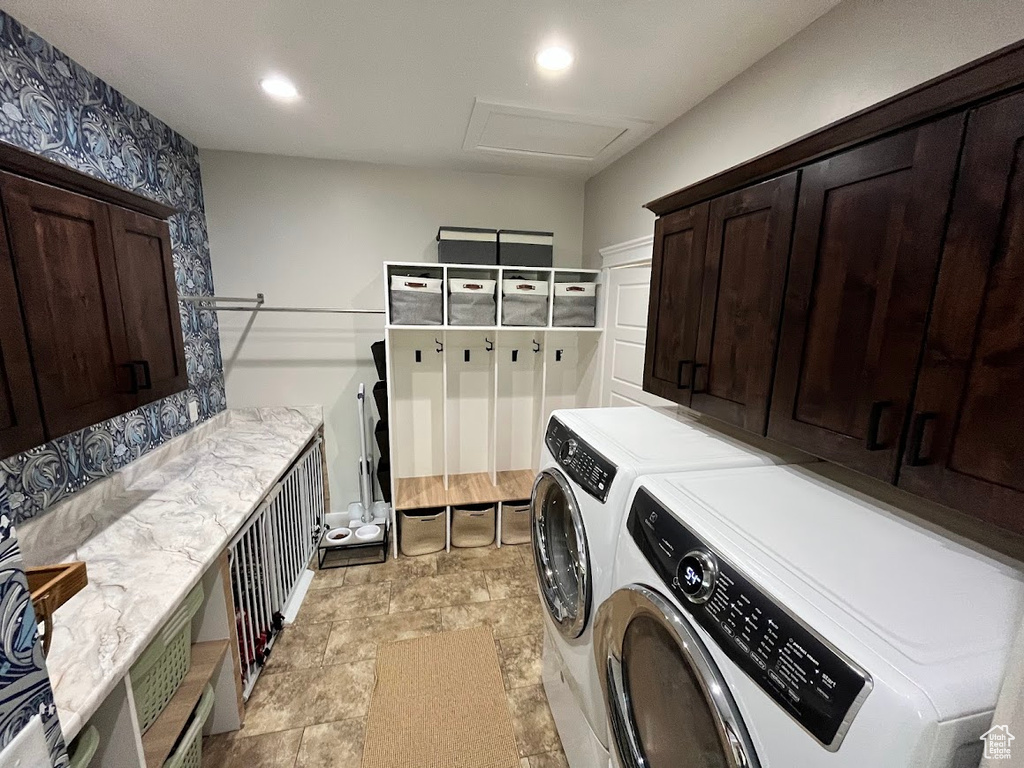 Washroom with cabinet space, washing machine and dryer, attic access, and recessed lighting