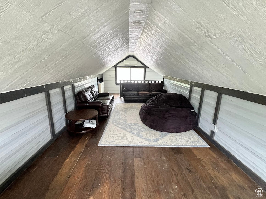 Bonus room featuring hardwood / wood-style floors and lofted ceiling