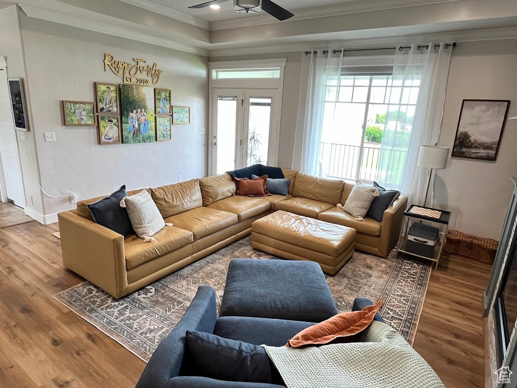 Living area featuring ornamental molding, wood finished floors, a ceiling fan, and recessed lighting