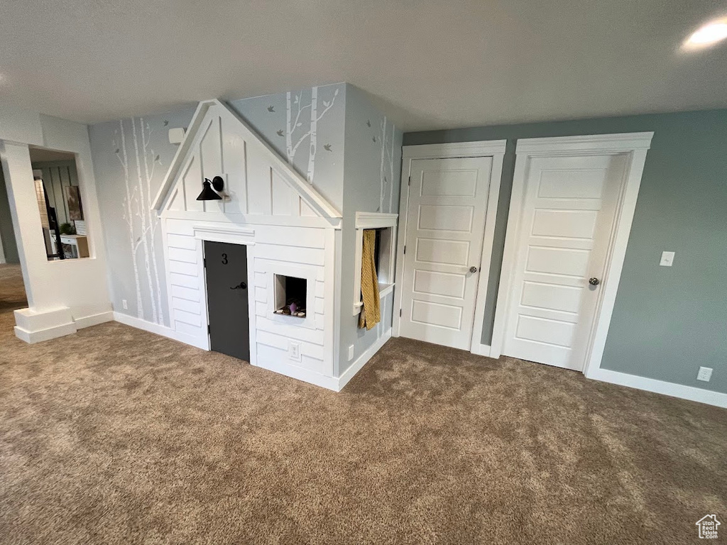 Unfurnished bedroom with carpet floors and baseboards