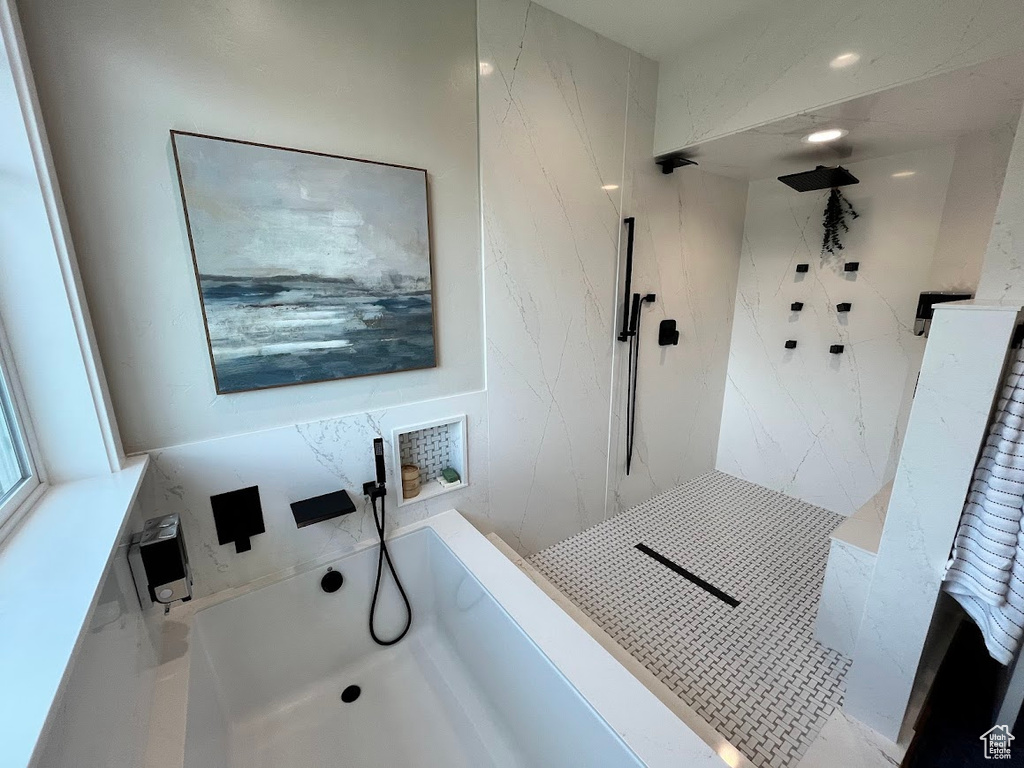 Full bathroom with a bath and a shower