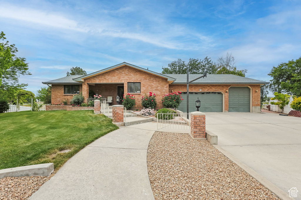 Ranch-style home featuring an attached garage, concrete driveway, brick siding, and a shingled roof