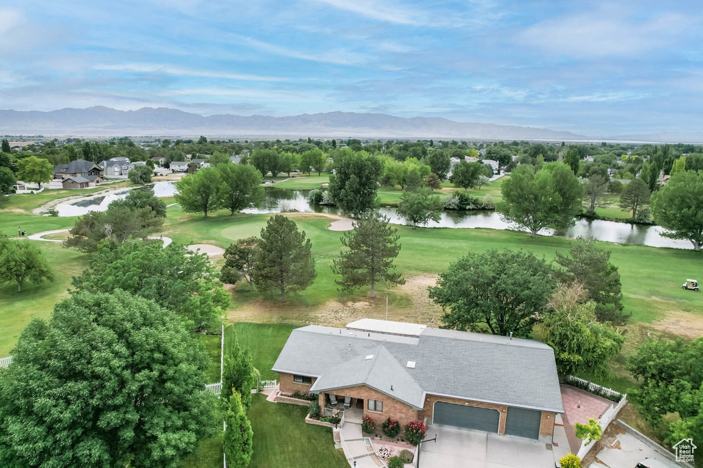 Aerial view of residential area featuring a water and mountain view and a local golf course