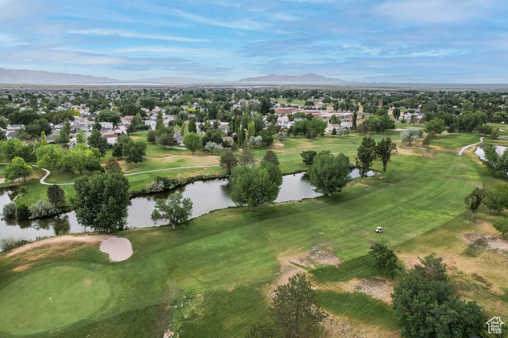 Aerial view of residential area with a water and mountain view and a golf course