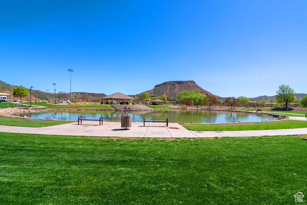 View of property's community with a yard, a water and mountain view, and a gazebo