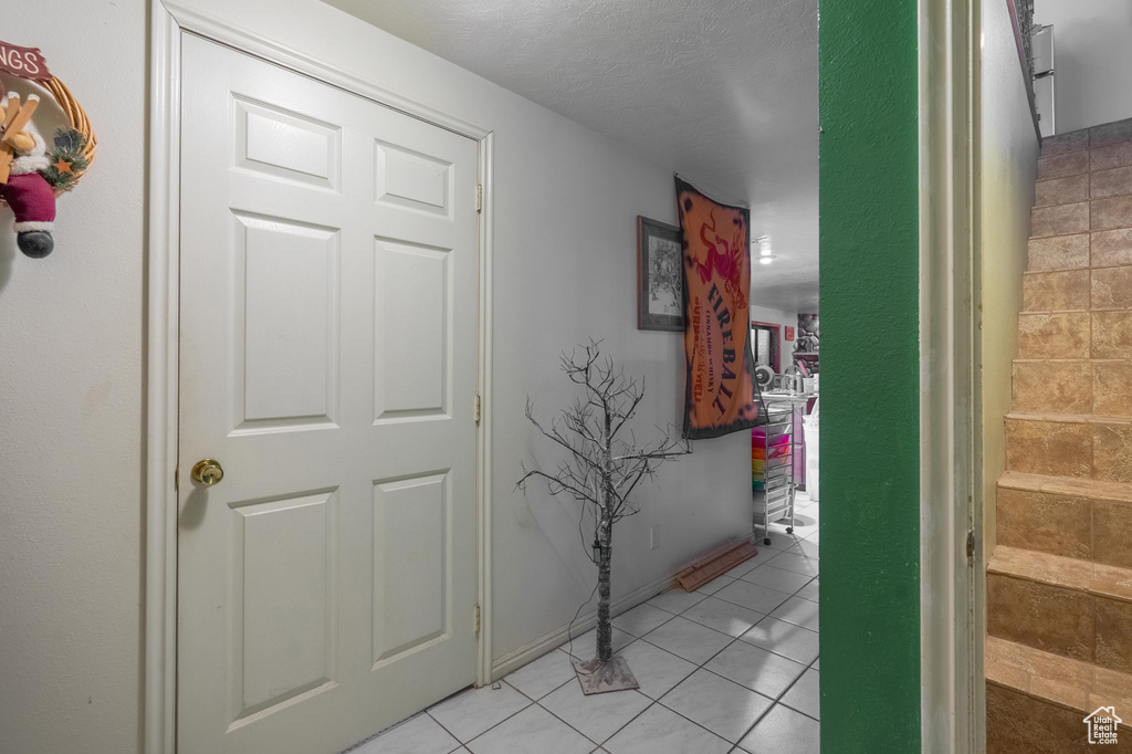Hall featuring light tile patterned flooring