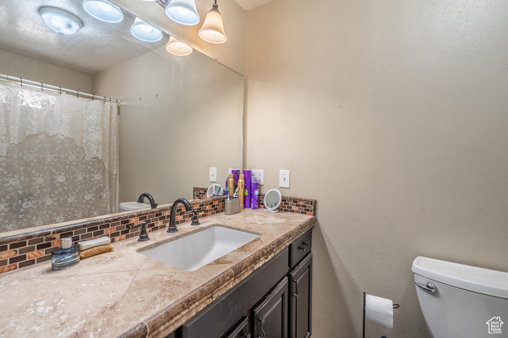 Bathroom featuring backsplash and vanity
