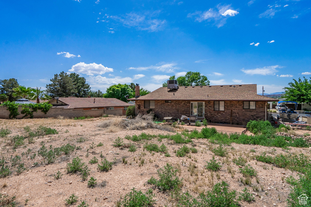 Rear view of property featuring a patio area and brick siding