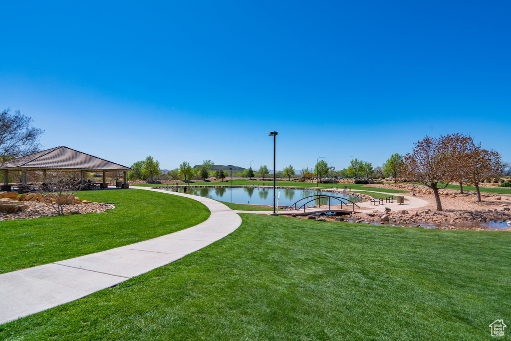 View of community featuring a lawn and a water view
