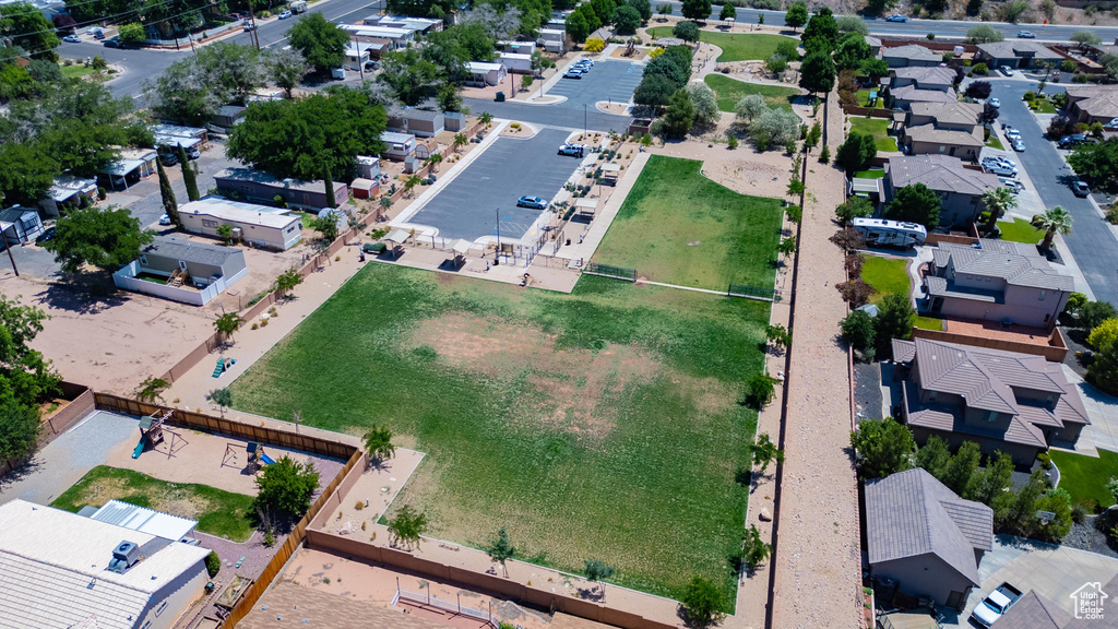 Aerial view of property and surrounding area featuring nearby suburban area