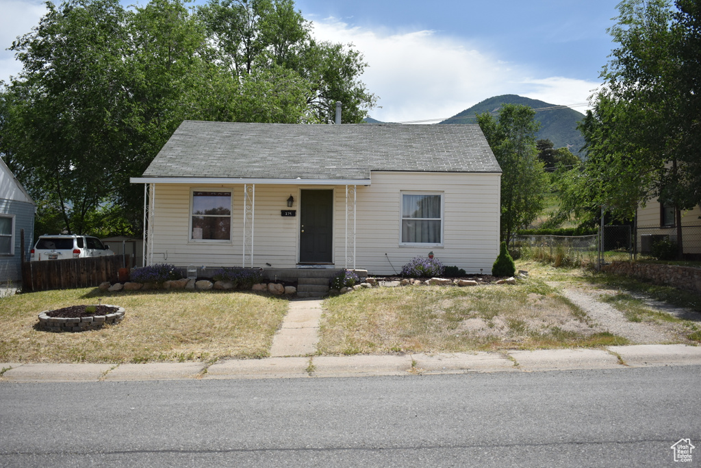 Bungalow-style home with a mountain view and a porch