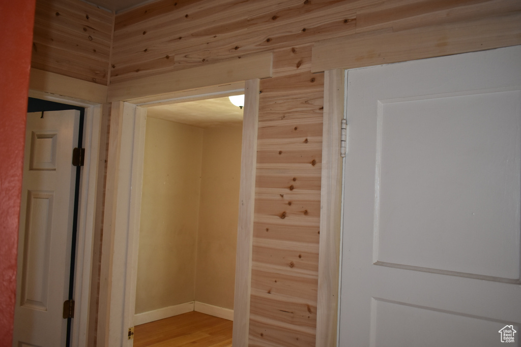 Hallway featuring light wood finished floors and baseboards