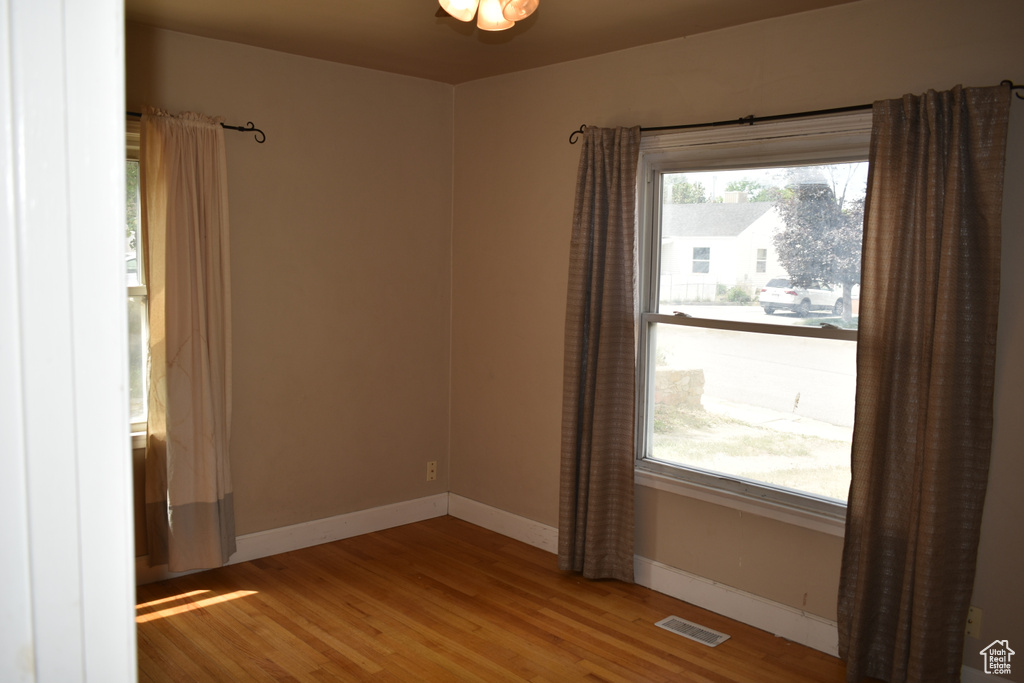 Spare room featuring wood finished floors and baseboards