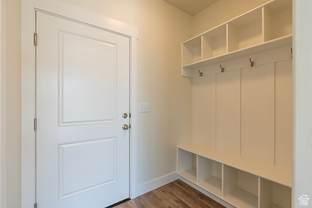 Mudroom featuring baseboards and dark wood finished floors