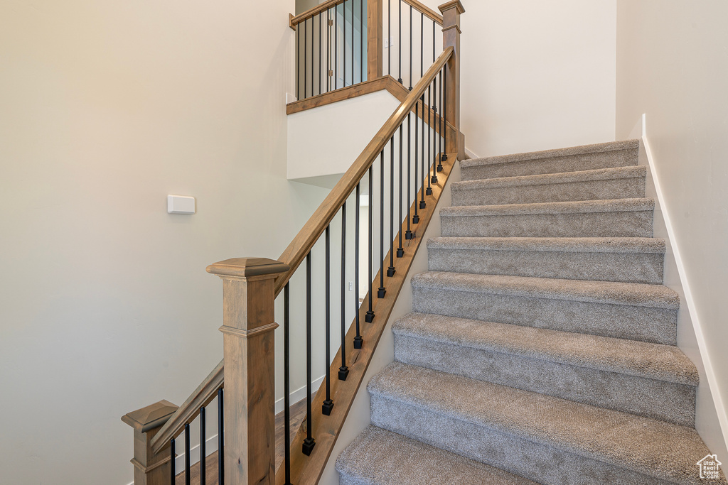 Stairway featuring a towering ceiling