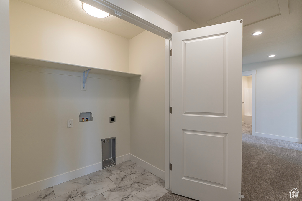 Washroom with electric dryer hookup, washer hookup, recessed lighting, and light marble finish flooring