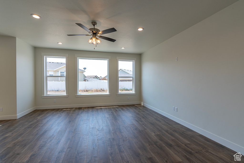 Unfurnished room with plenty of natural light, dark wood-type flooring, ceiling fan, and recessed lighting