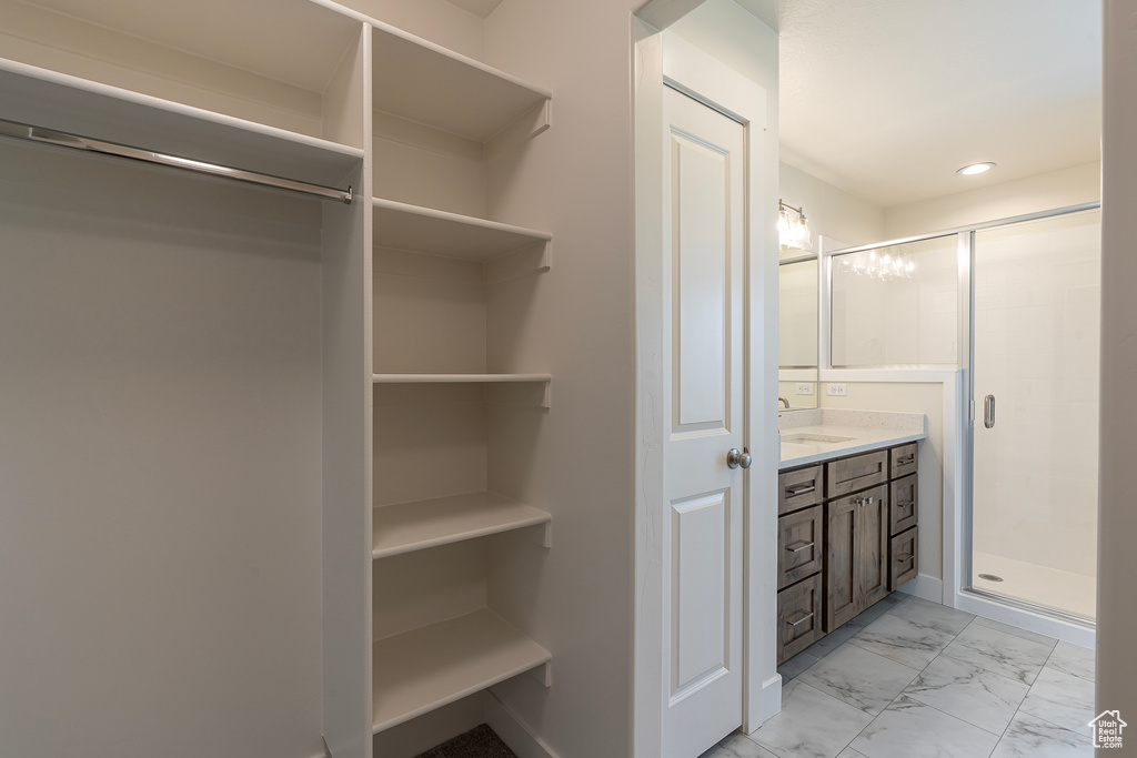 Bathroom with vanity, a shower stall, marble finish flooring, recessed lighting, and a spacious closet