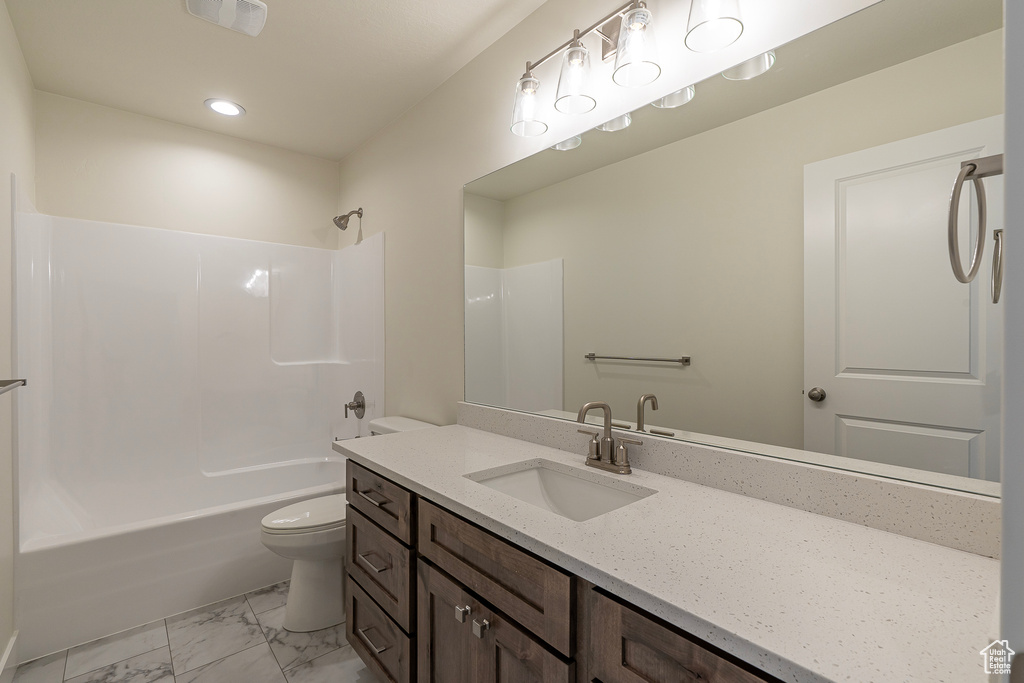 Full bathroom featuring vanity, tub / shower combination, marble finish floors, and recessed lighting