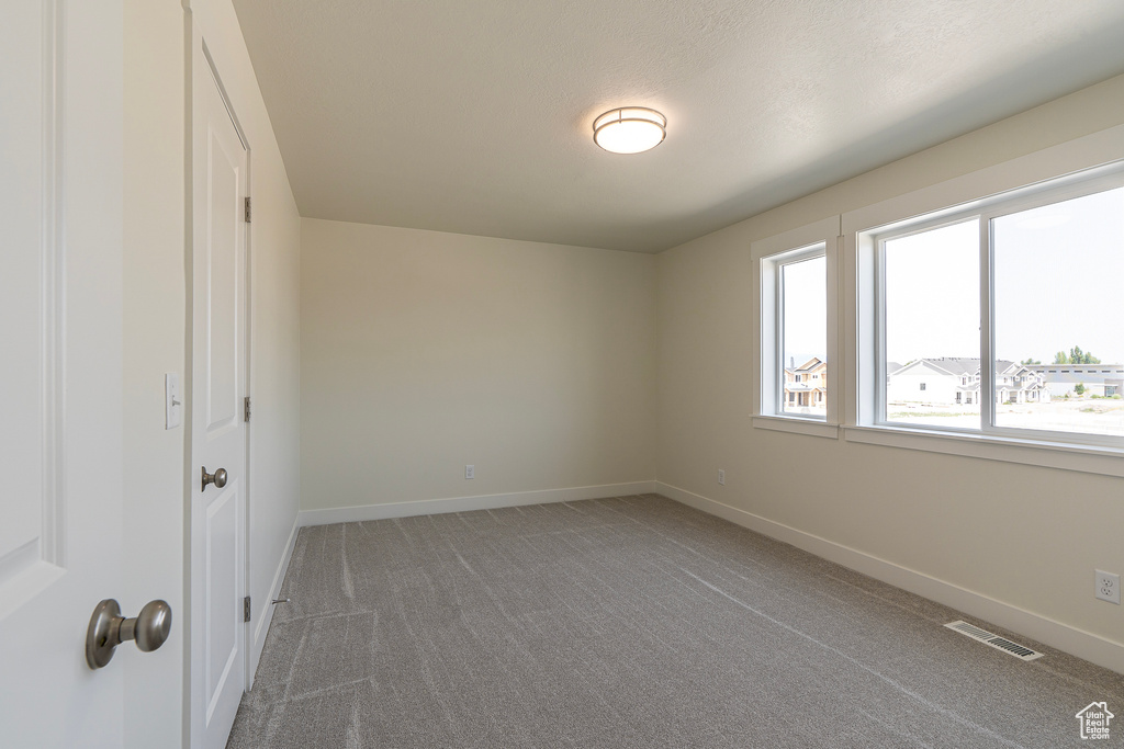 Unfurnished bedroom featuring carpet floors and baseboards