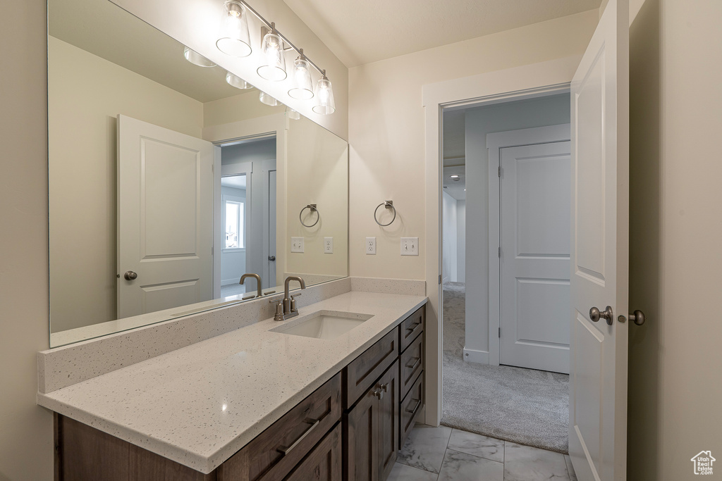 Bathroom featuring vanity and marble finish flooring