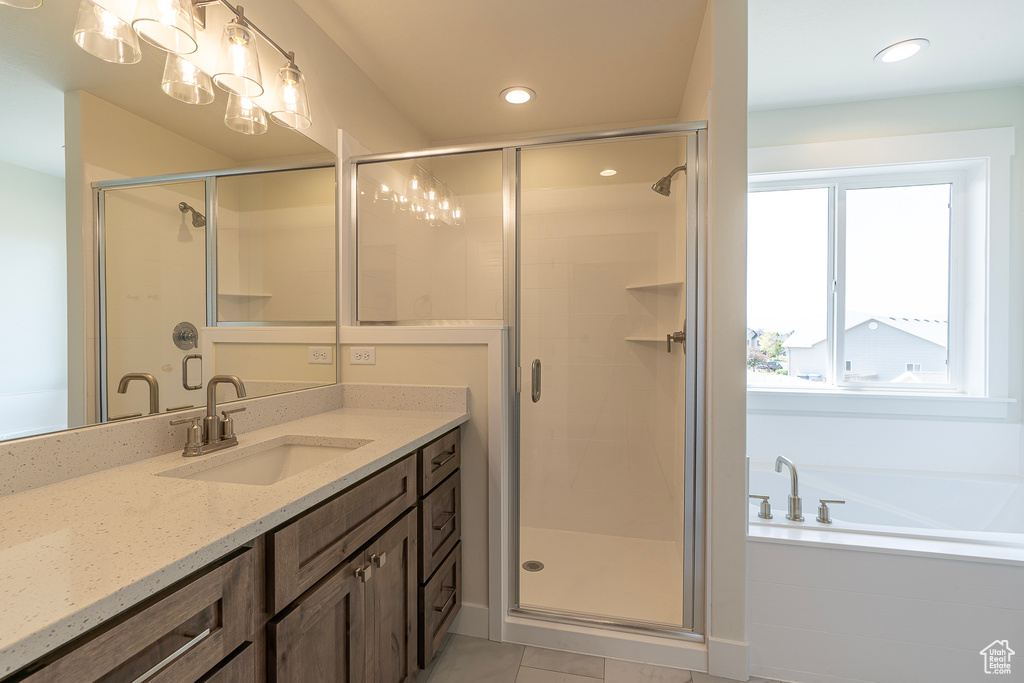 Bathroom featuring vanity, a shower stall, a bath, tile patterned floors, and recessed lighting