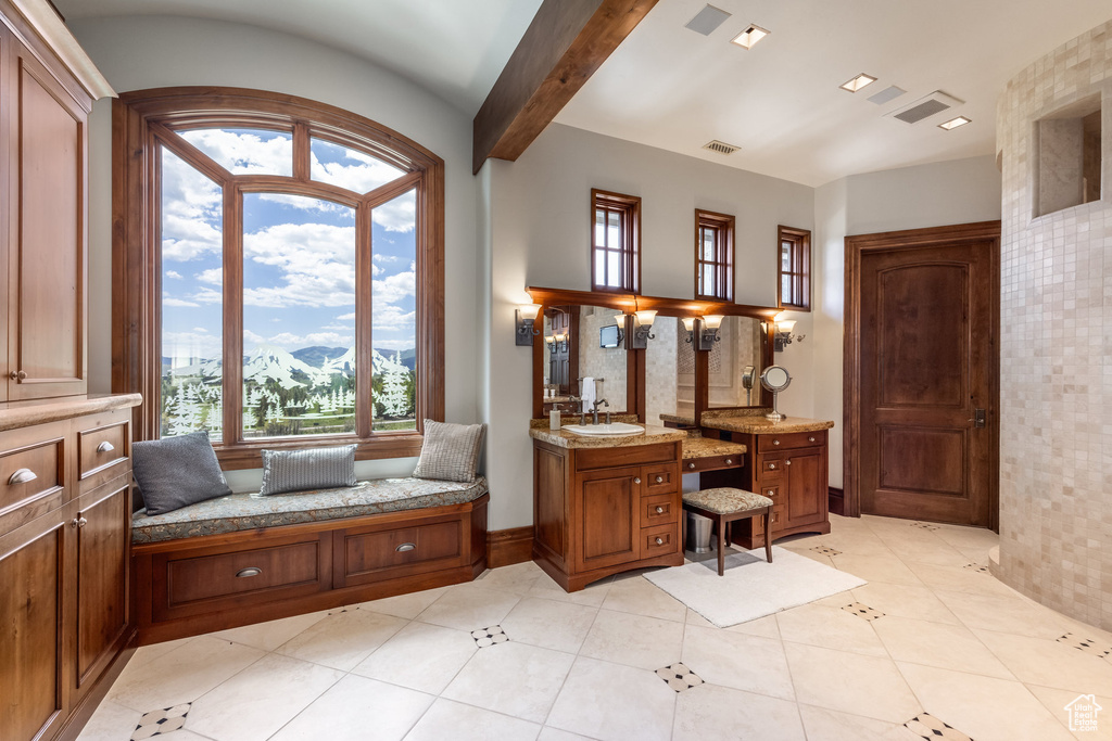 Bathroom with a mountain view, vanity, plenty of natural light, and tile patterned floors
