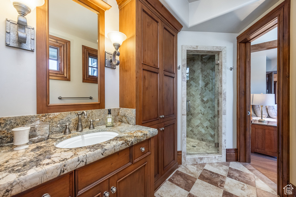 Full bath with vanity and a stall shower