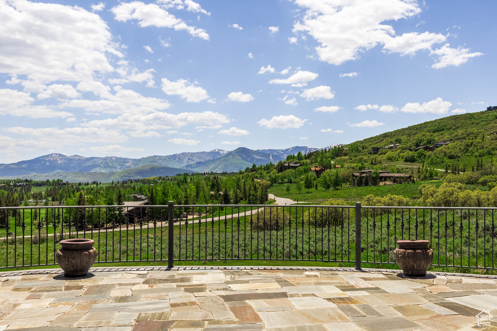 View of mountain backdrop featuring a heavily wooded area