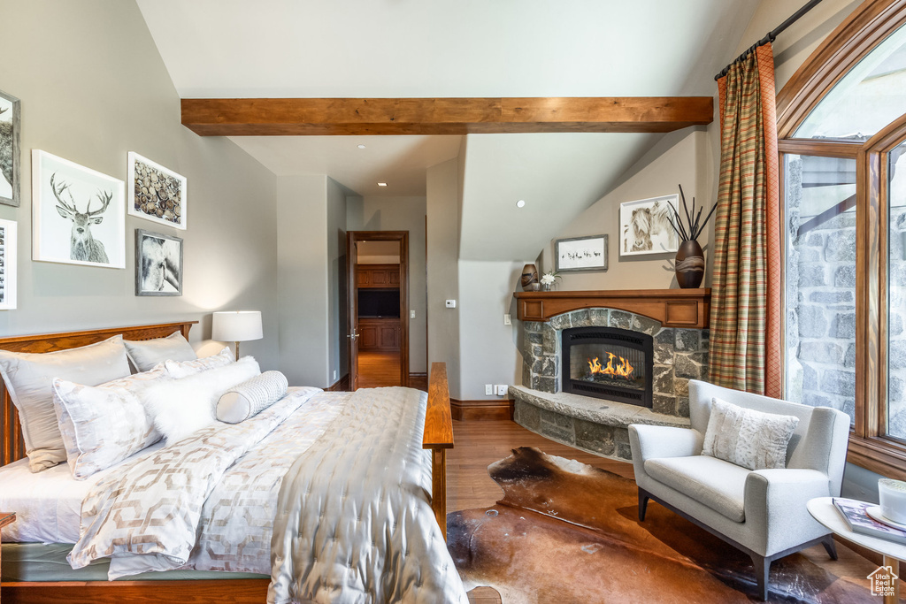 Bedroom with wood finished floors, a fireplace, and recessed lighting