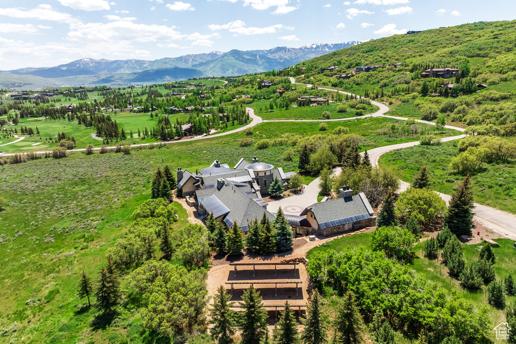 Aerial view of property and surrounding area with mountains