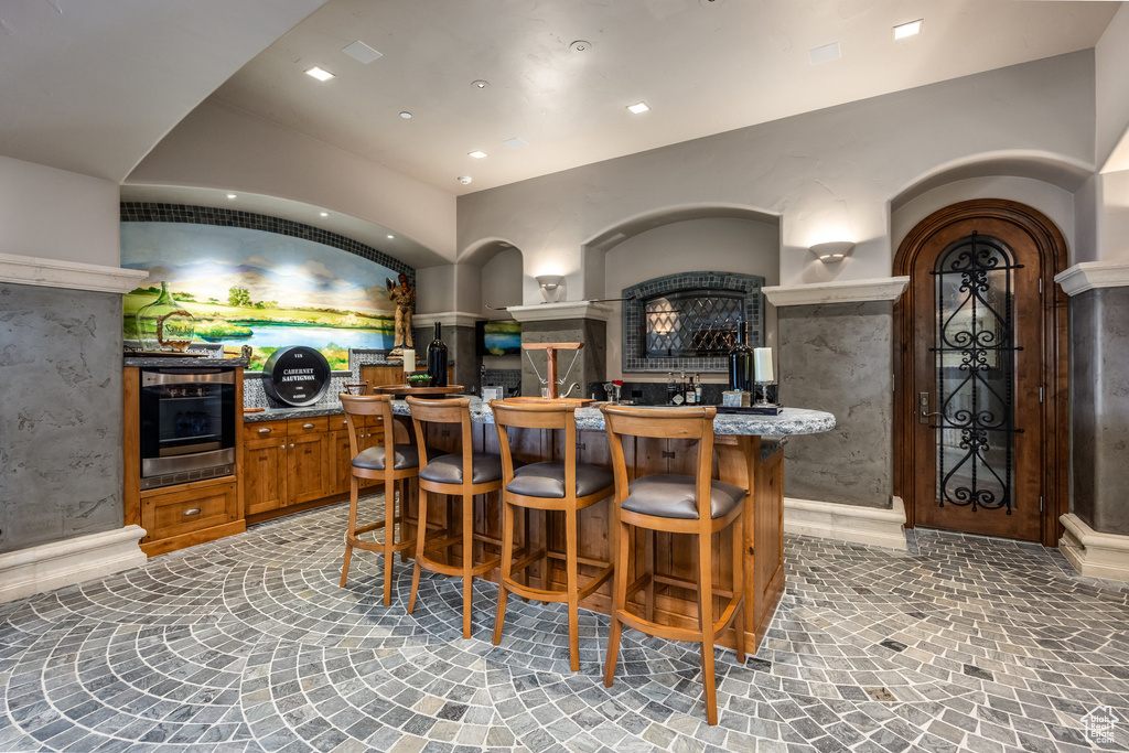 Indoor wet bar featuring oven and recessed lighting