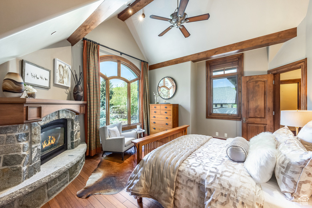 Bedroom with hardwood / wood-style floors, a fireplace, and a ceiling fan
