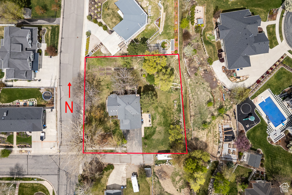 Aerial perspective of suburban area featuring property boundaries highlighted