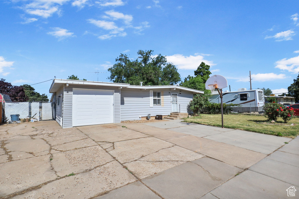 View of front of house featuring concrete driveway, entry steps, and an attached garage