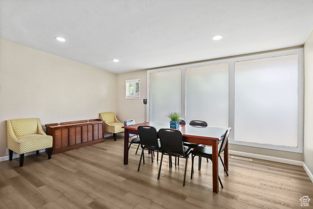 Dining area featuring wood finished floors and recessed lighting