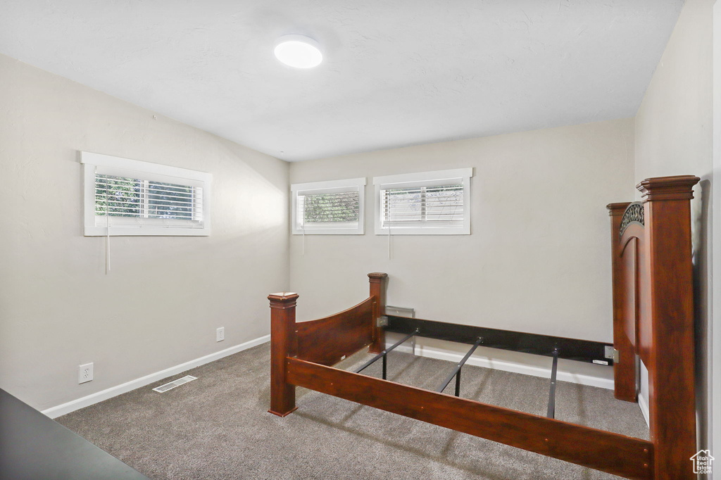 Bedroom with carpet floors and baseboards