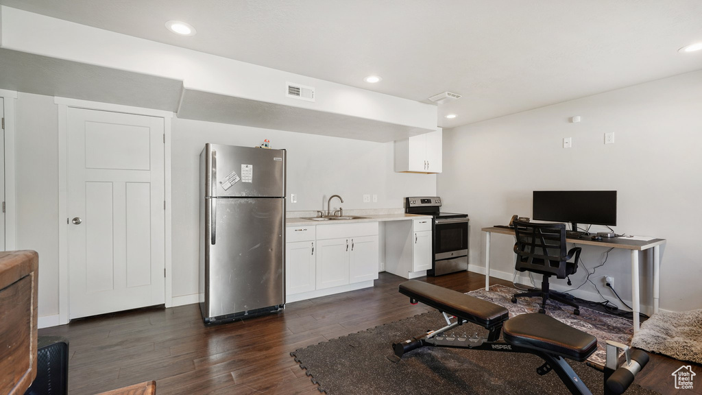 Office space featuring dark wood-style floors and recessed lighting