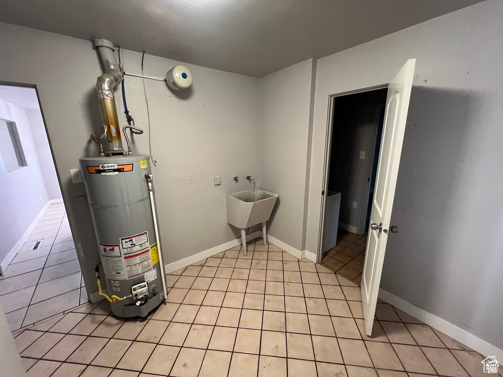 Utilities with water heater and a sink
