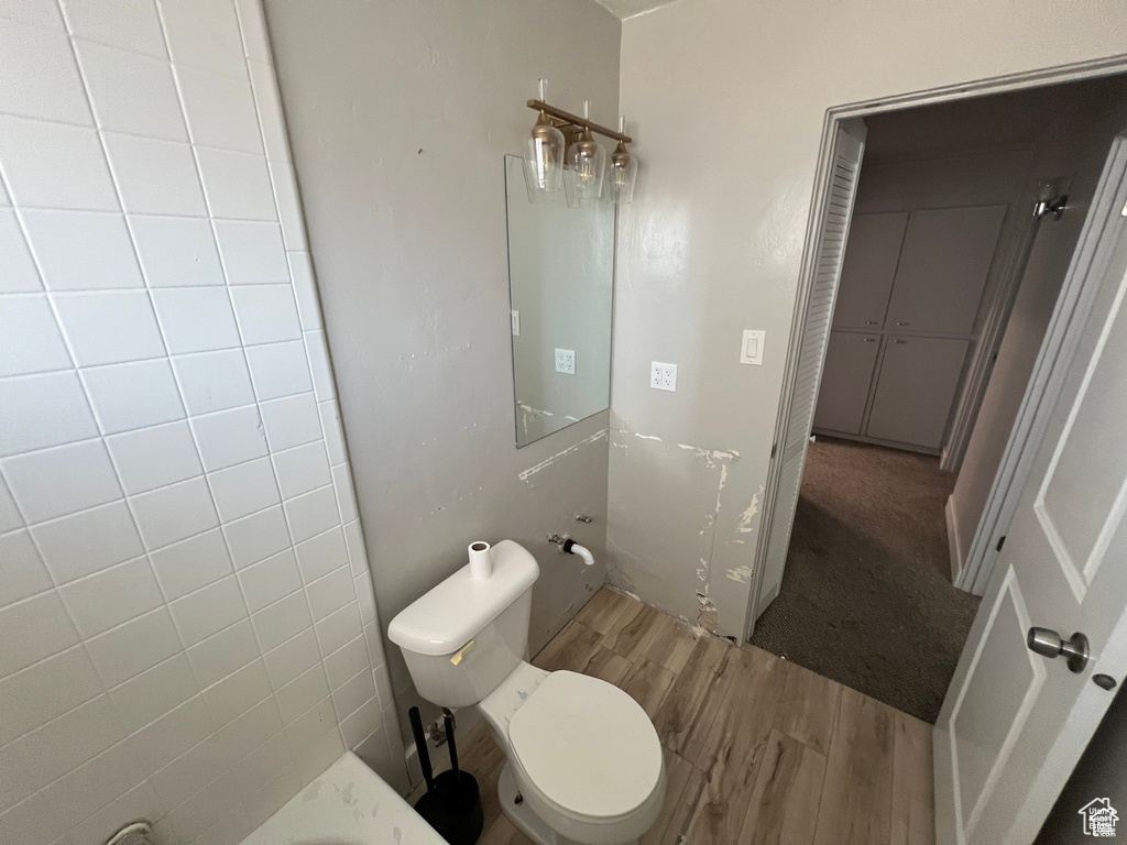 Bathroom featuring wood finished floors and toilet
