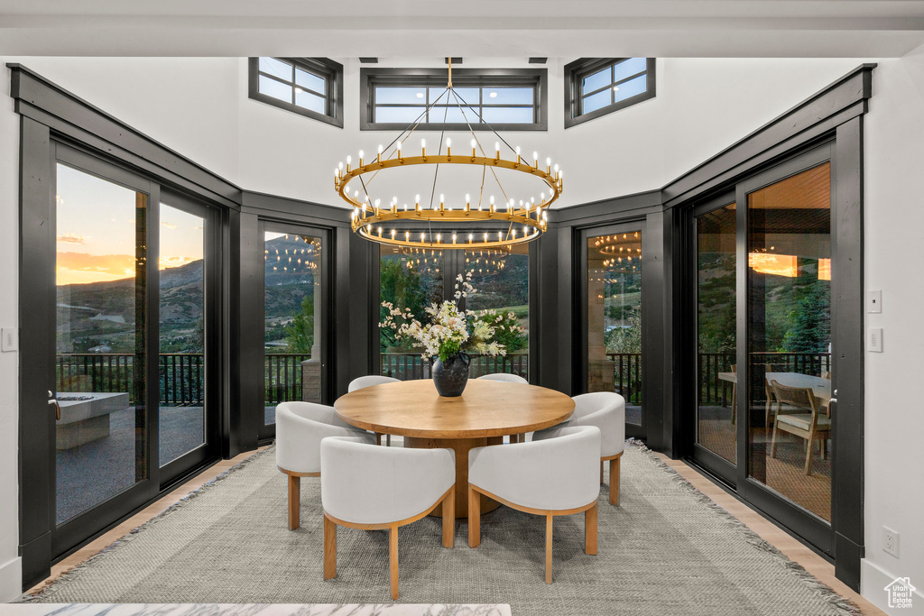 Dining room featuring a chandelier and a towering ceiling