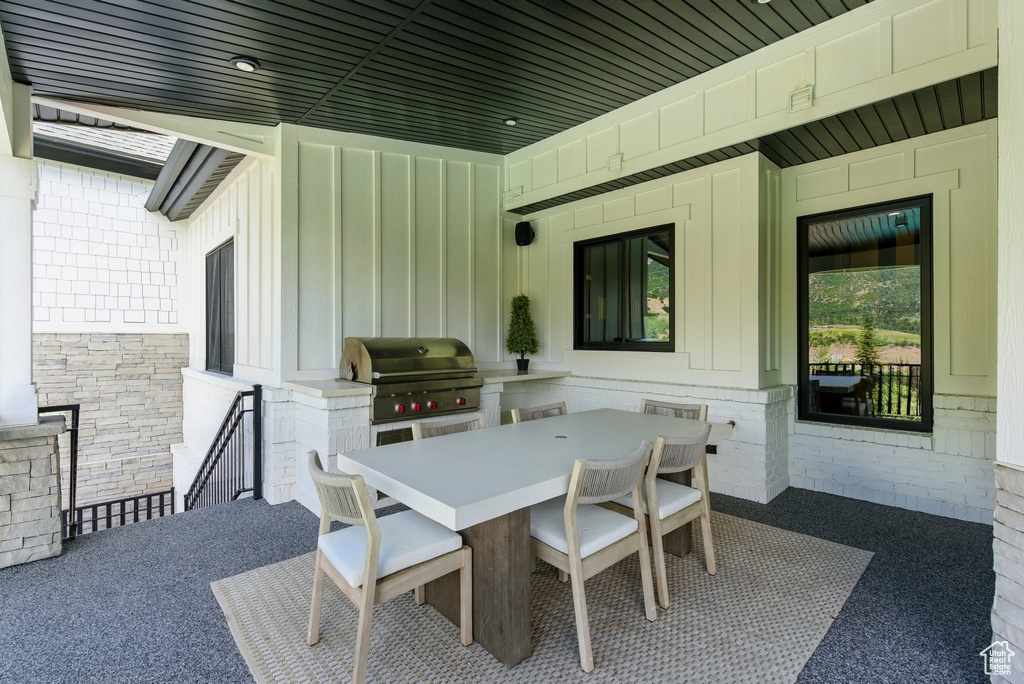 View of patio featuring outdoor dining space and an outdoor kitchen