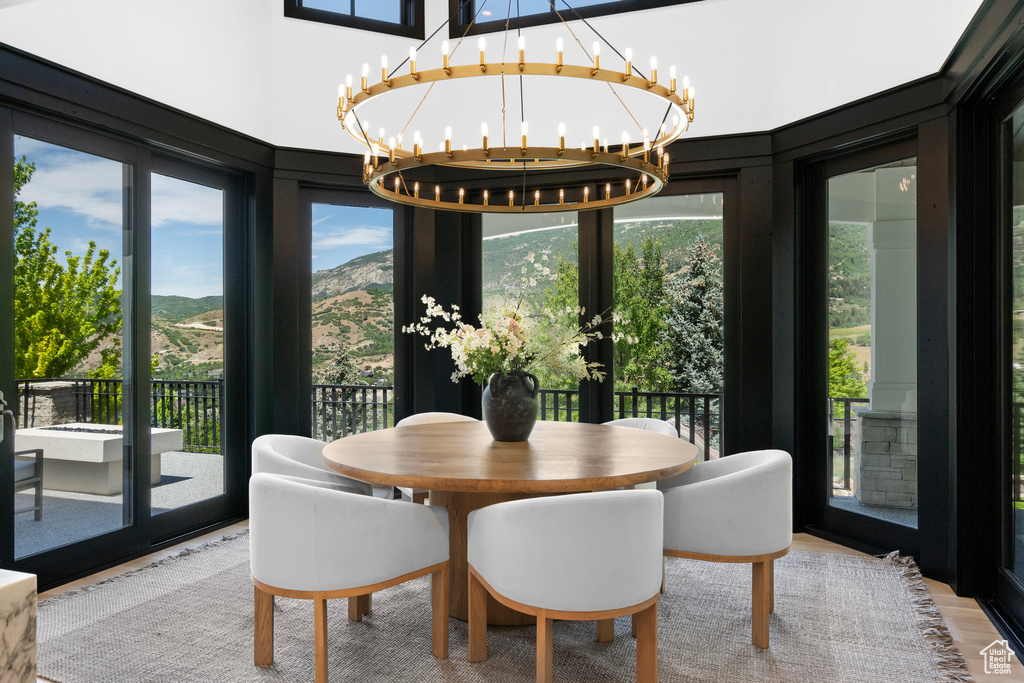 Dining room featuring a chandelier, a mountain view, and wood finished floors