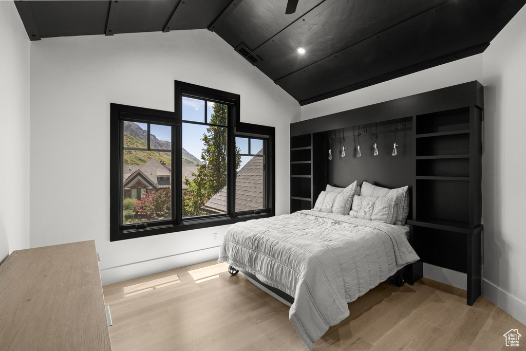 Bedroom featuring vaulted ceiling and wood finished floors