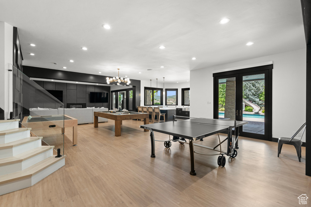 Recreation room featuring recessed lighting, light wood finished floors, billiards table, a chandelier, and french doors