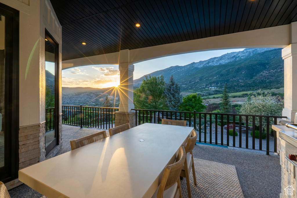 Balcony featuring a mountain view and outdoor dining area