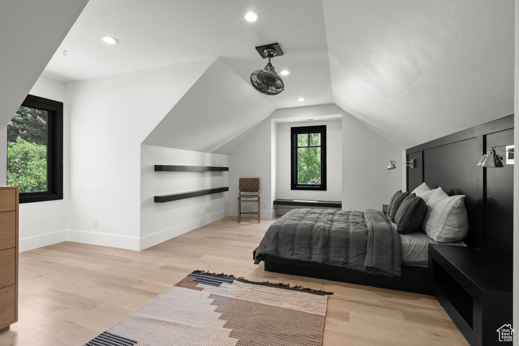 Bedroom featuring light wood-style floors, lofted ceiling, and recessed lighting